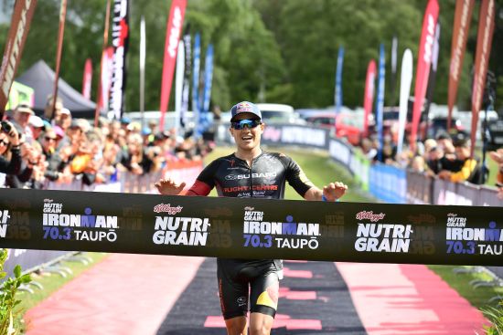 Braden Currie breaks the tape to win Ironman 70.3 Taupo