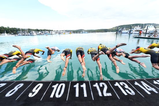 Athletes dive off the pontoon at Hamilton Island Marina